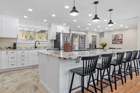 Additional seating at the kitchen counter offers a cozy spot for casual meals