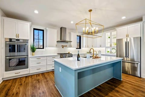 A modern kitchen featuring top of the line Thermador stainless steel appliances including a double oven, six burner range, drawer microwave oven, extra capacity dishwasher and refrigerator.