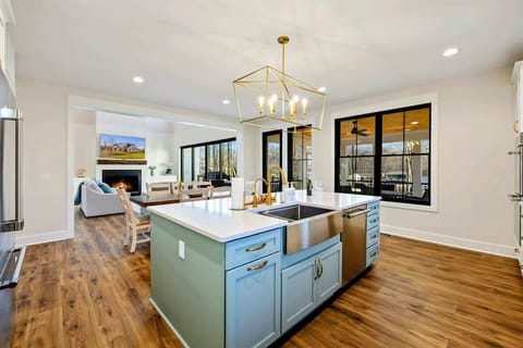 A modern kitchen featuring top of the line Thermador stainless steel appliances including a double oven, six burner range, drawer microwave oven, extra capacity dishwasher and refrigerator.