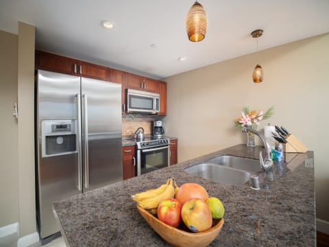 Prepare meals in a modern kitchen with sleek stainless steel appliances, granite countertops, and stylish pendant lighting—perfect for family gatherings or group vacations.