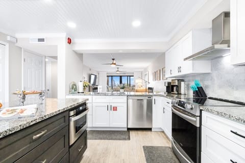 Fully equipped modern kitchen with ample counter space and stainless steel appliances.