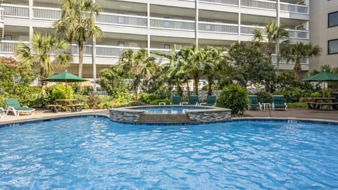 Relax in the hot tub or pool with loungers nearby.