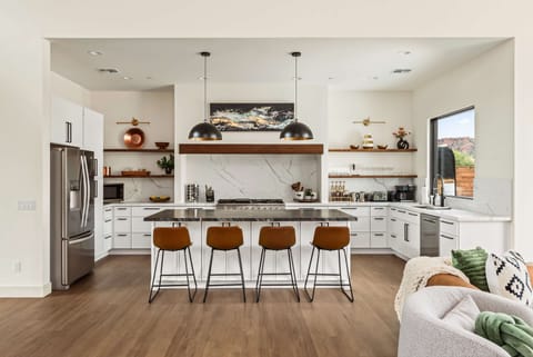 Spacious kitchen with beautiful counters, perfect for cooking and connection.