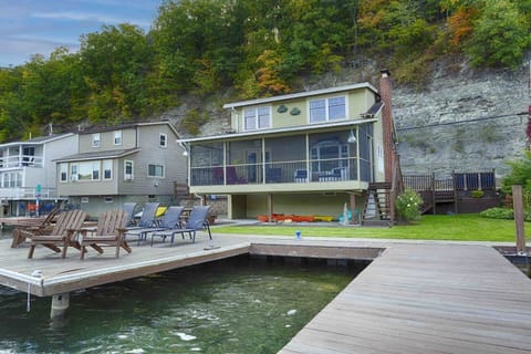 Nestled at the edge of a serene lake, this charming dock features a row of inviting, comfortable chairs, perfect for relaxing and enjoying the peaceful surroundings. The chairs, crafted from weather-resistant materials, are designed for comfort with 