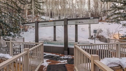 Infinity lap pool and hot tub spa on upper level