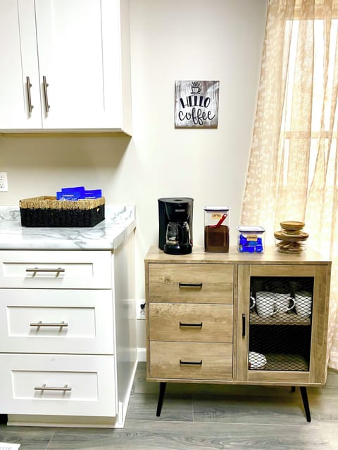 Fully stocked coffee bar and snack basket in the kitchen.