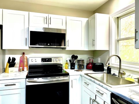 Fully stocked kitchen including spice rack and essentials. Dishwasher.