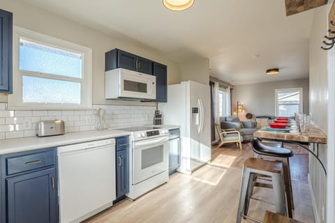 Flooded with natural light, this inviting culinary haven features chic barstool seating, perfect for morning coffee, casual bites, or gathering with friends!