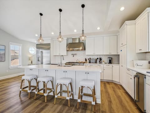 Sleek and modern kitchen with a breakfast bar and bright design, creating an ideal hub for family meals.