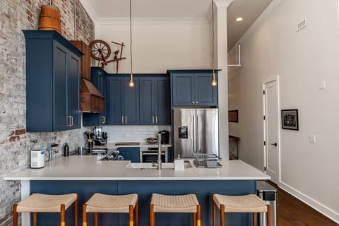 Kitchen comes stocked with essentials, a Keurig Coffee Maker, blender, toaster, and is open the living space. Down the hall are the beds and baths