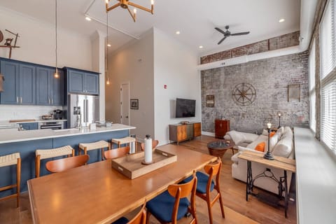 The open concept great room with downtown views, exposed brick walls, 20ft ceilings, natural light and the comforts of home all await you at #501