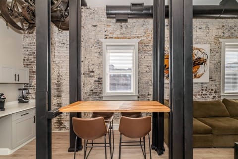 View of the dining area between the coffee bar and living space