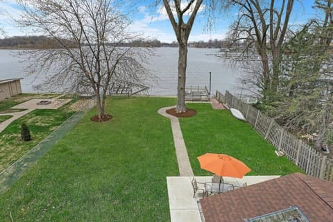 Drone shot of the fenced in back yard to the lake