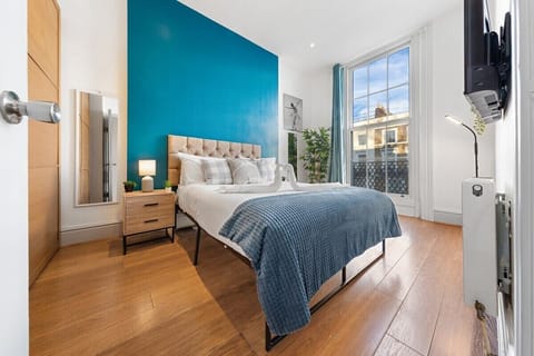 Cozy king-size bed with soft lighting and modern décor