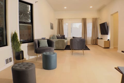 Bright and open living room with stylish seating, perfect for unwinding or entertaining guests.