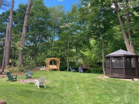 Expansive backyard with plenty of room for yard games or socializing by the fire pit at night. Relax in the oversized, arbor swing set and listen to Jewell Brook babble behind you or find peace & quiet in the completely screened-in 360° gazebo.