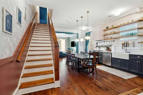 View of the kitchen with the staircase leading to the large upstairs bedroom.