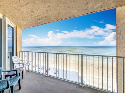Spacious balcony offering panoramic views of the beach and ocean, perfect for enjoying the fresh sea breeze and breathtaking coastal scenery.