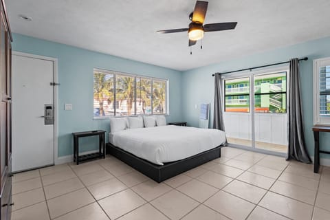 Large spacious room on the 2nd Floor of the Cove Building, features private balcony with a partial ocean view.