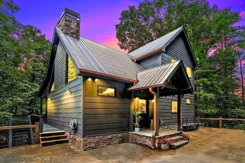 Cozy cabin vibes with warm lighting and a stunning sunset backdrop.