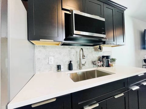 Coffee station with a variety of supplies, set against a beautiful hexagonal backsplash for a stylish start to your day.