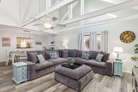 Living area with large couch featuring a flat screen tv.