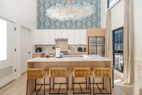 Sleek and modern, this kitchen shines with stainless steel appliances and a spacious island with bar seating for four.