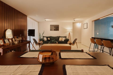 Dining and living area with access to a balcony and panoramic view.