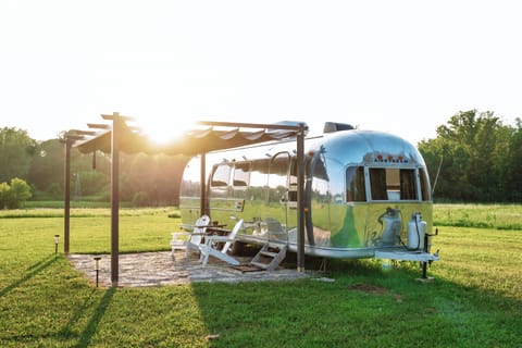 1971 renovated airstream with shady pergola on 80 acre rescue farm