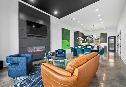 This spacious living room offers plenty of seating, modern decor, and a welcoming ambiance—perfect for spending quality time with family or friends.