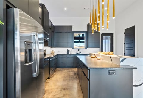 A spacious and thoughtfully designed kitchen with state-of-the-art appliances, a striking island, and plenty of counter space to inspire culinary creativity.