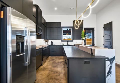 This beautifully designed kitchen offers the best of modern style and functionality, with expansive counter space and a layout that flows effortlessly into the home.