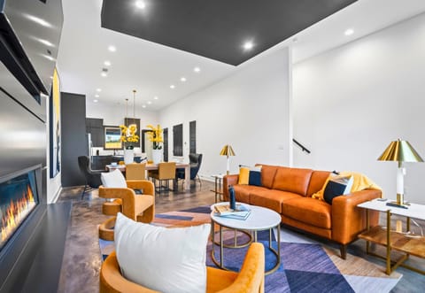 A beautifully designed living room with sleek furniture, a cozy fireplace, and bold accents, perfect for unwinding in style.