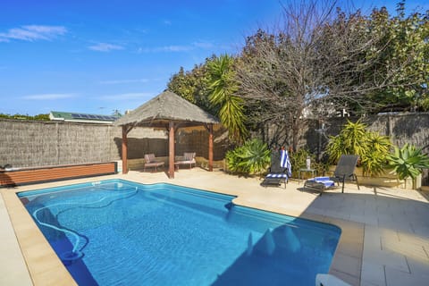 Private pool surrounded by lush outdoor space