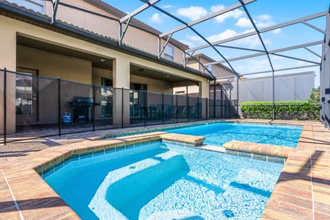 Dive into relaxation in this sparkling private pool, complete with an attached spa, all enclosed in a screened lanai for added privacy. The spacious patio includes outdoor seating and a BBQ grill, making it perfect for family