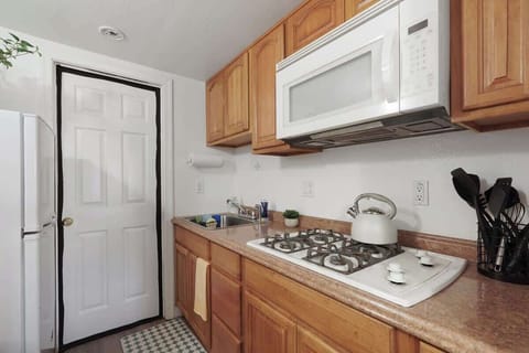 Compact kitchen with essential appliances and a simple setup for easy meal prep.
