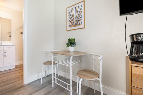 A charming dining space for two, perfect for morning coffee or a quick meal. Bright decor and thoughtful touches make this corner inviting and functional.