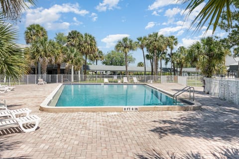 Dive into the expansive pool area, surrounded by tropical landscaping and plenty of seating for a perfect day in the sun.