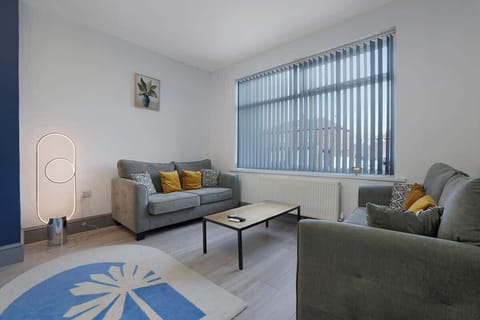 Enjoy a bright and comfortable living room complete with two sofas, a sofa bed for an extra guest, a wall-mounted television, a dedicated desk, and reliable Wi-Fi, making it ideal for both business and leisure stays.