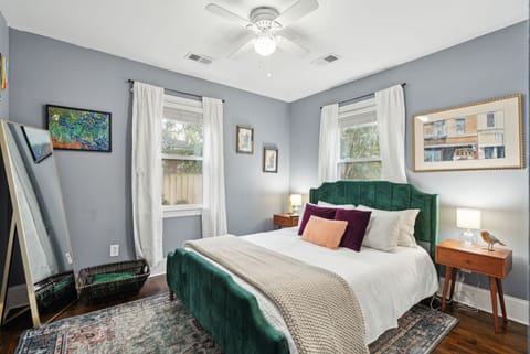 Bedroom #1 with queen-sized bed, smart TV, & small closet for clothing storage