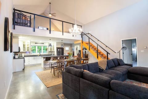 Kitchen, dining room, living room and loft/office- door on right going to primary suite and sliding doors to hot tub! Great area for family gatherings where you can cook and gather in one great room with everything you need right here!