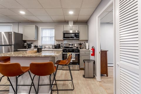Floor 1 -Casual Dining Space Features a granite island with four stylish leather barstools—perfect for meals, morning coffee, or socializing while cooking.