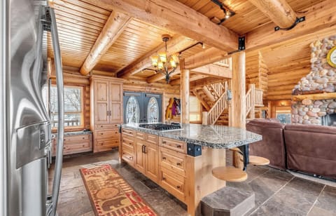 Kitchen area with large bar with seating.