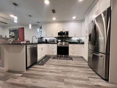 Fully Renovated kitchen with quartz countertops stainless steel appliances & bar seating