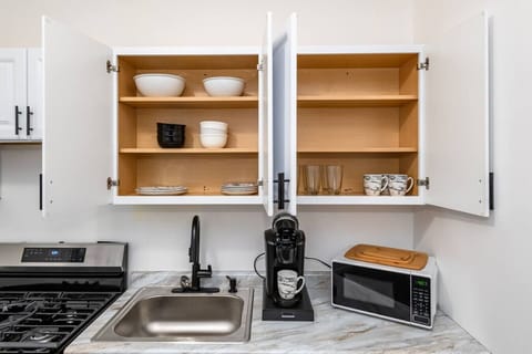 Kitchen shelves with essential utensils.