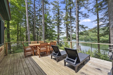 Outdoor dining area for six and two sun beds to relax with the beautiful view of the lake.
