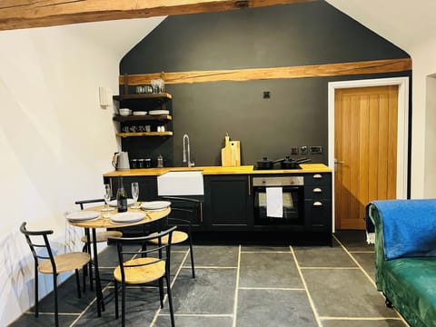 Kitchen with cooker hob kettle toaster fridge coffee tea and sugar provided