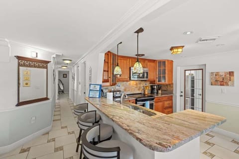 Prepare meals in style with the spacious L-shaped counter, offering plenty of room for cooking and entertaining #NaplesVacation