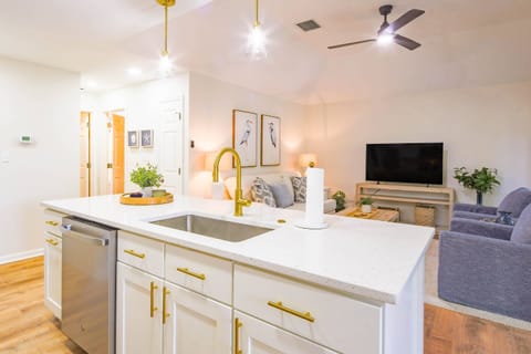 The kitchen's central island looks out onto the villa's comfortable living room.