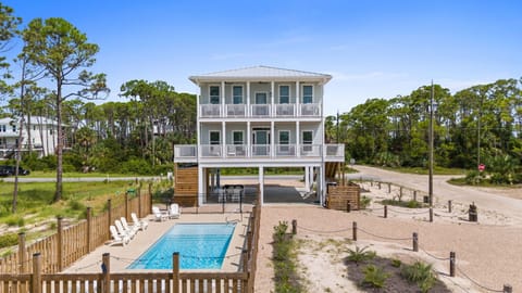 Exterior Facing the Gulf with Pool and Driveway